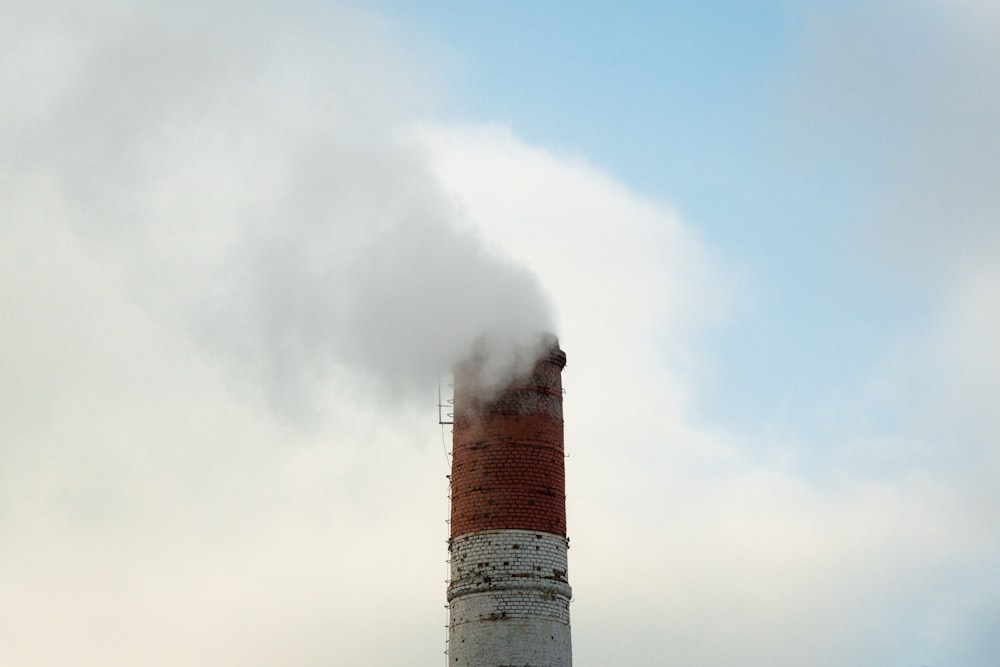 white and brown lighthouse under white clouds