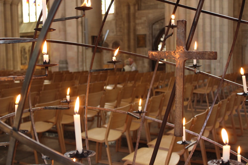 lighted candles on brown metal candle holder