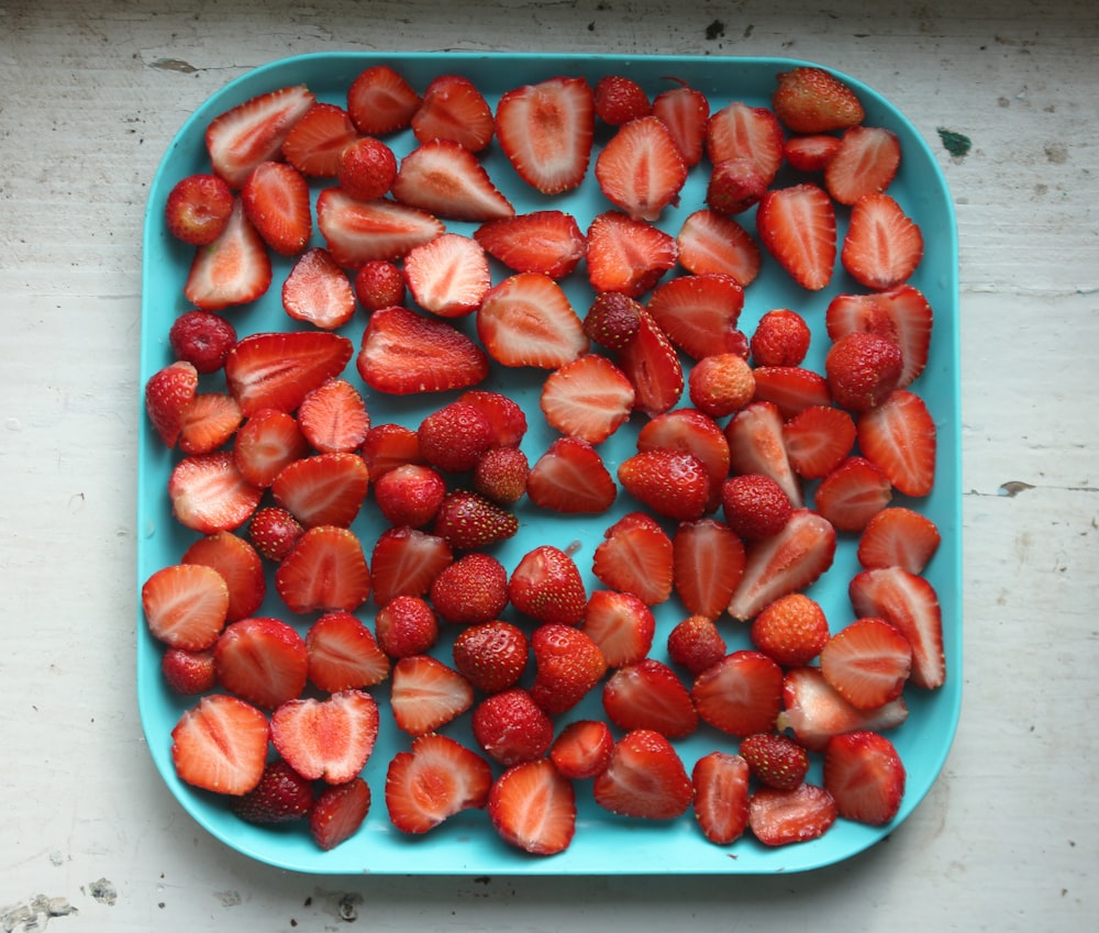 red strawberries on white ceramic bowl