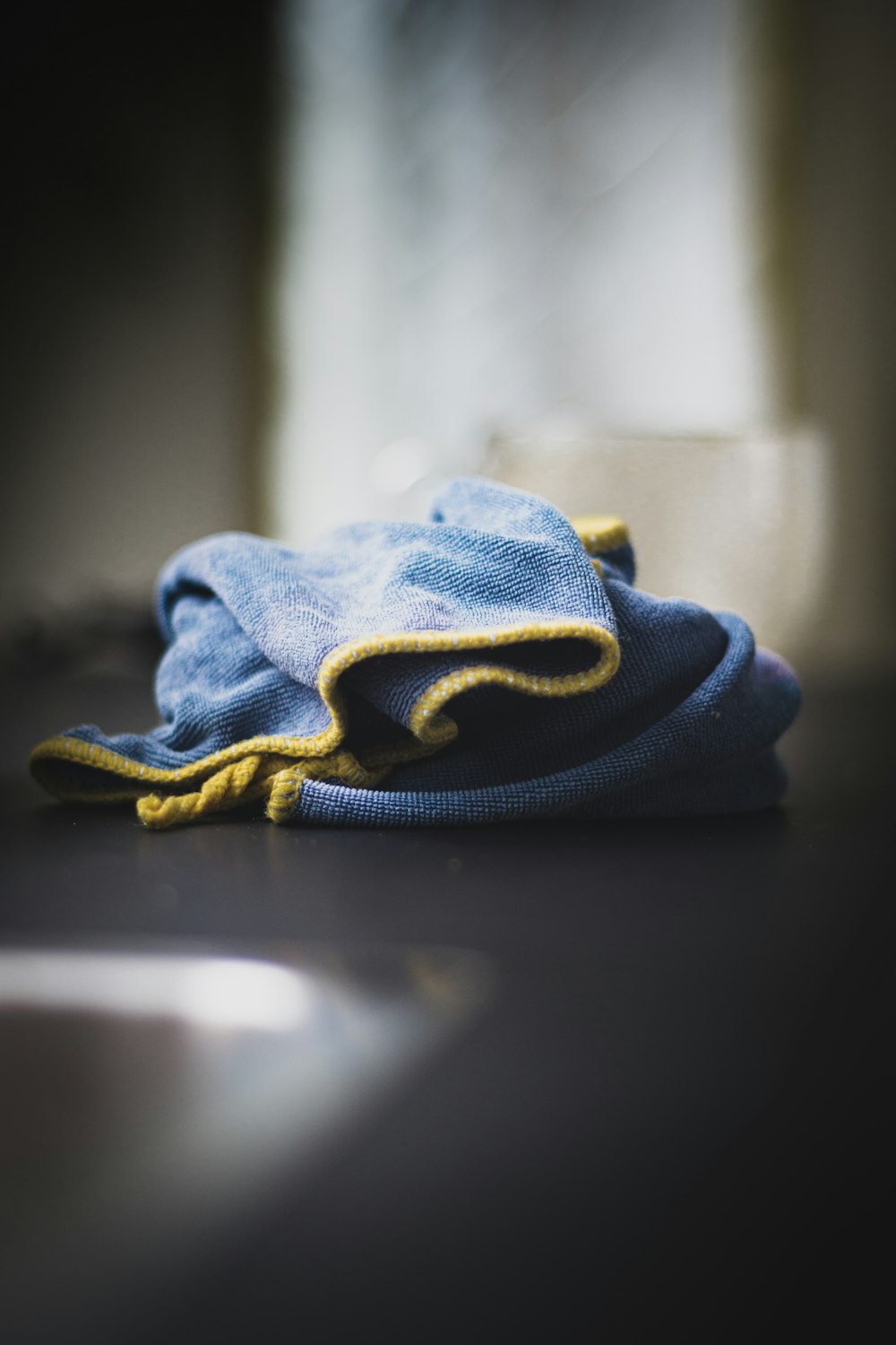 blue denim textile on black table