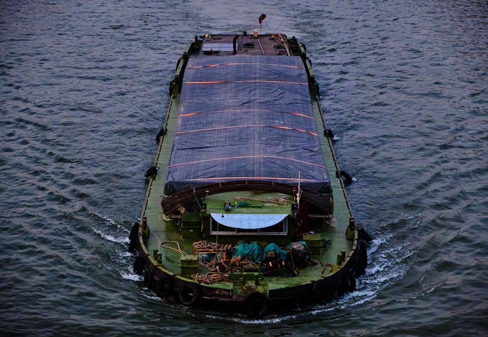 green and brown boat on sea during daytime