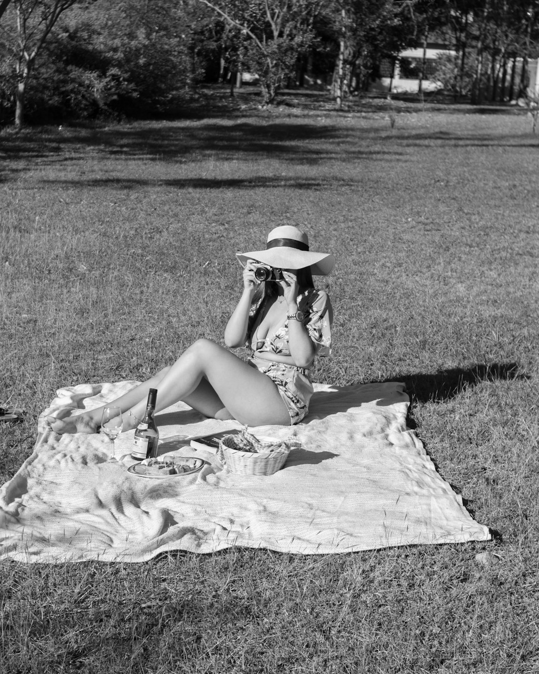 woman in white dress sitting on grass field