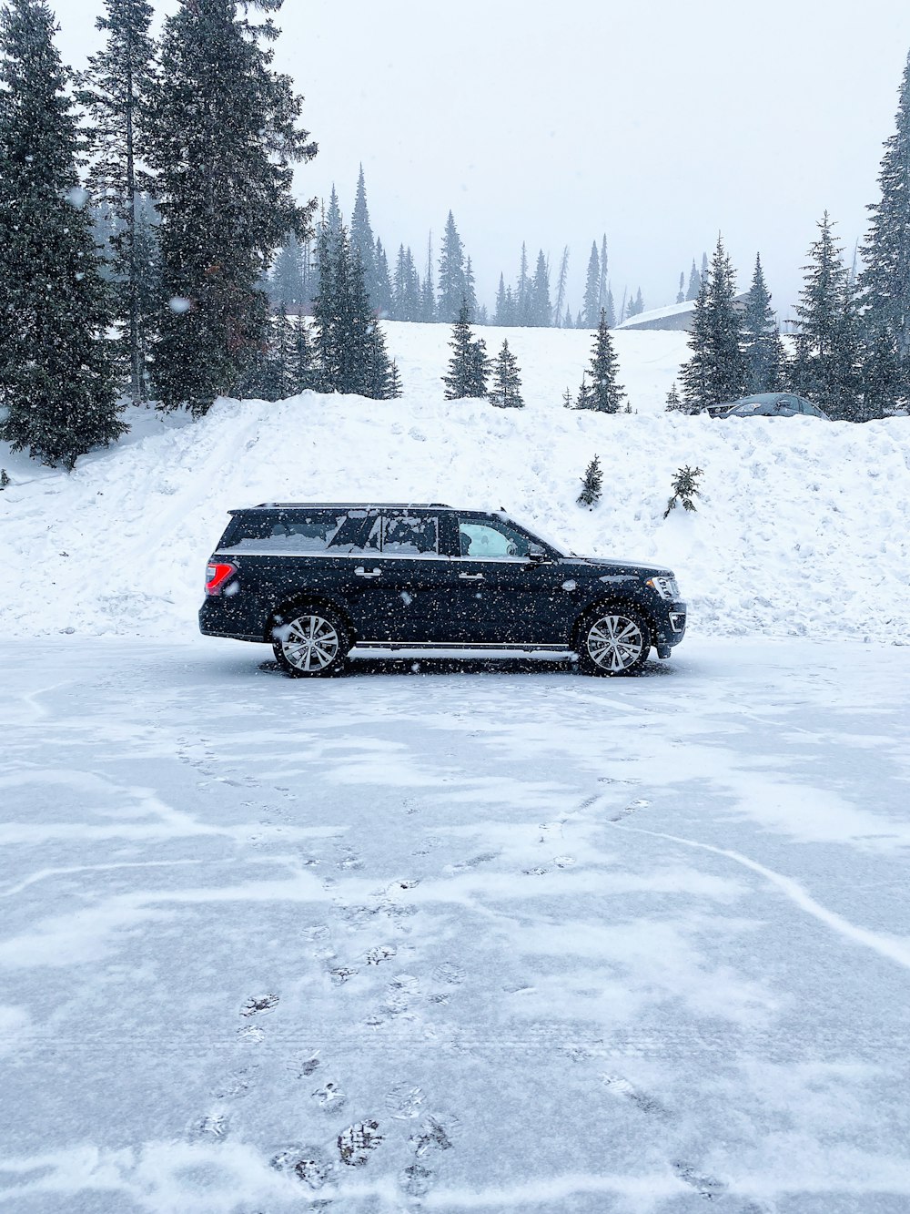 black suv on snow covered ground