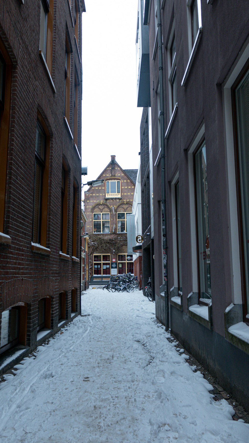 brown brick building covered with snow during daytime