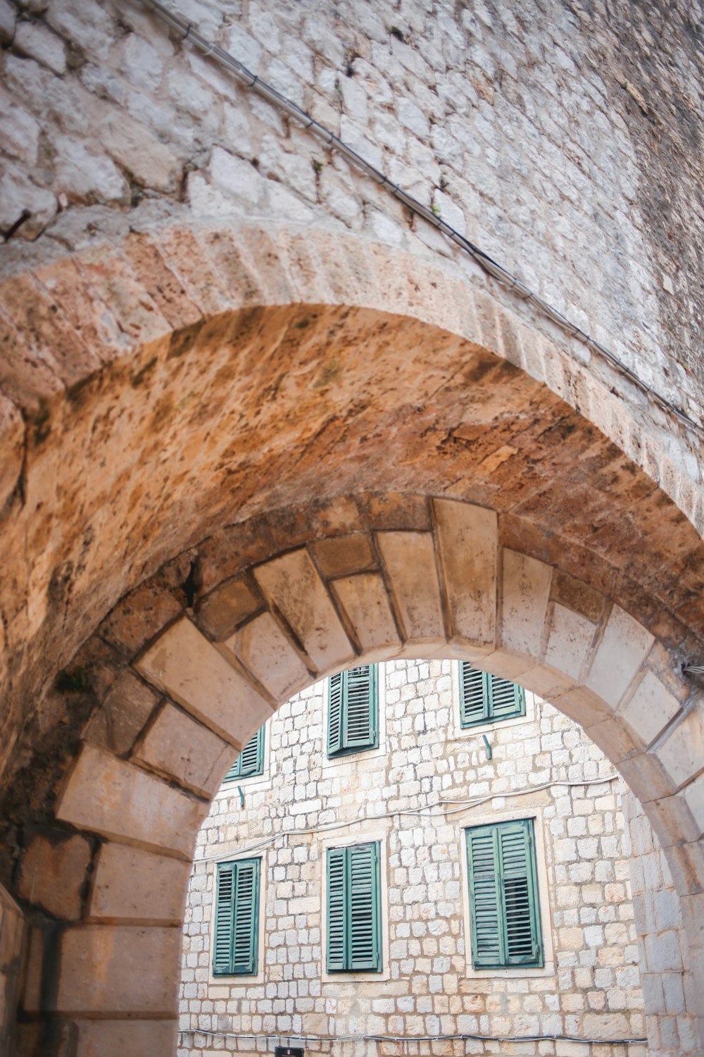 brown brick tunnel with white wooden door