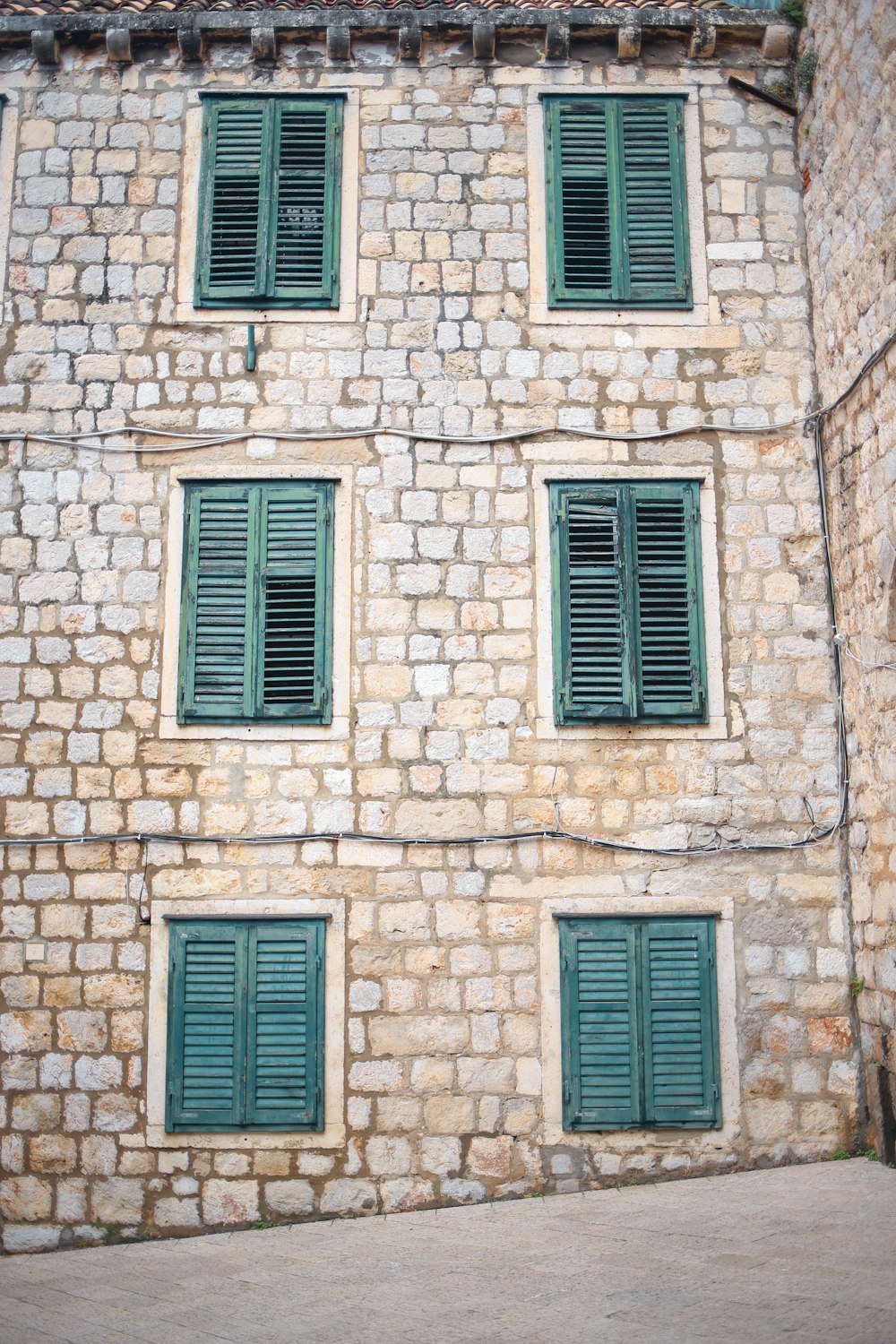 brown brick wall with white wooden windows