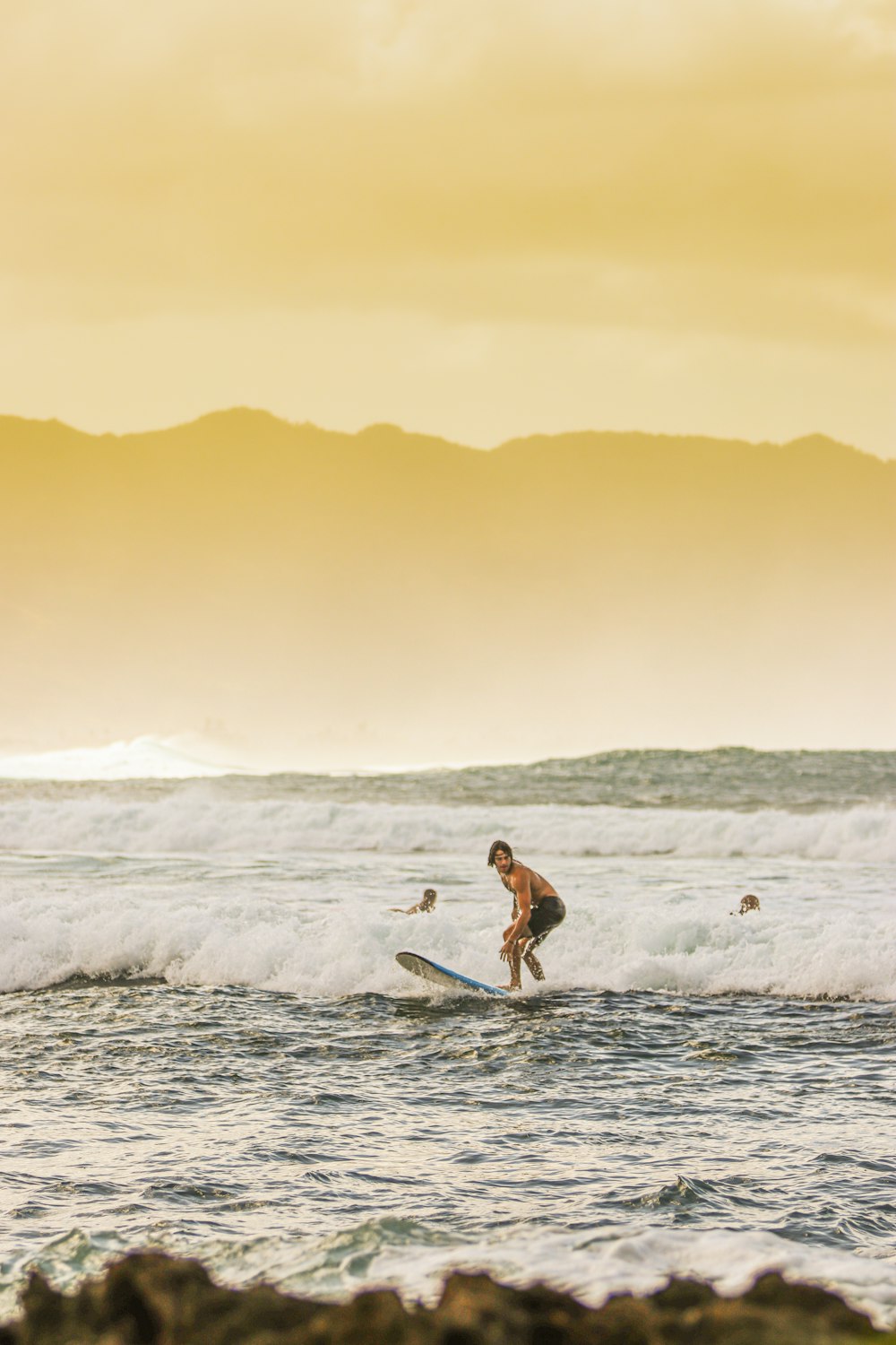 man surfing on sea waves during daytime