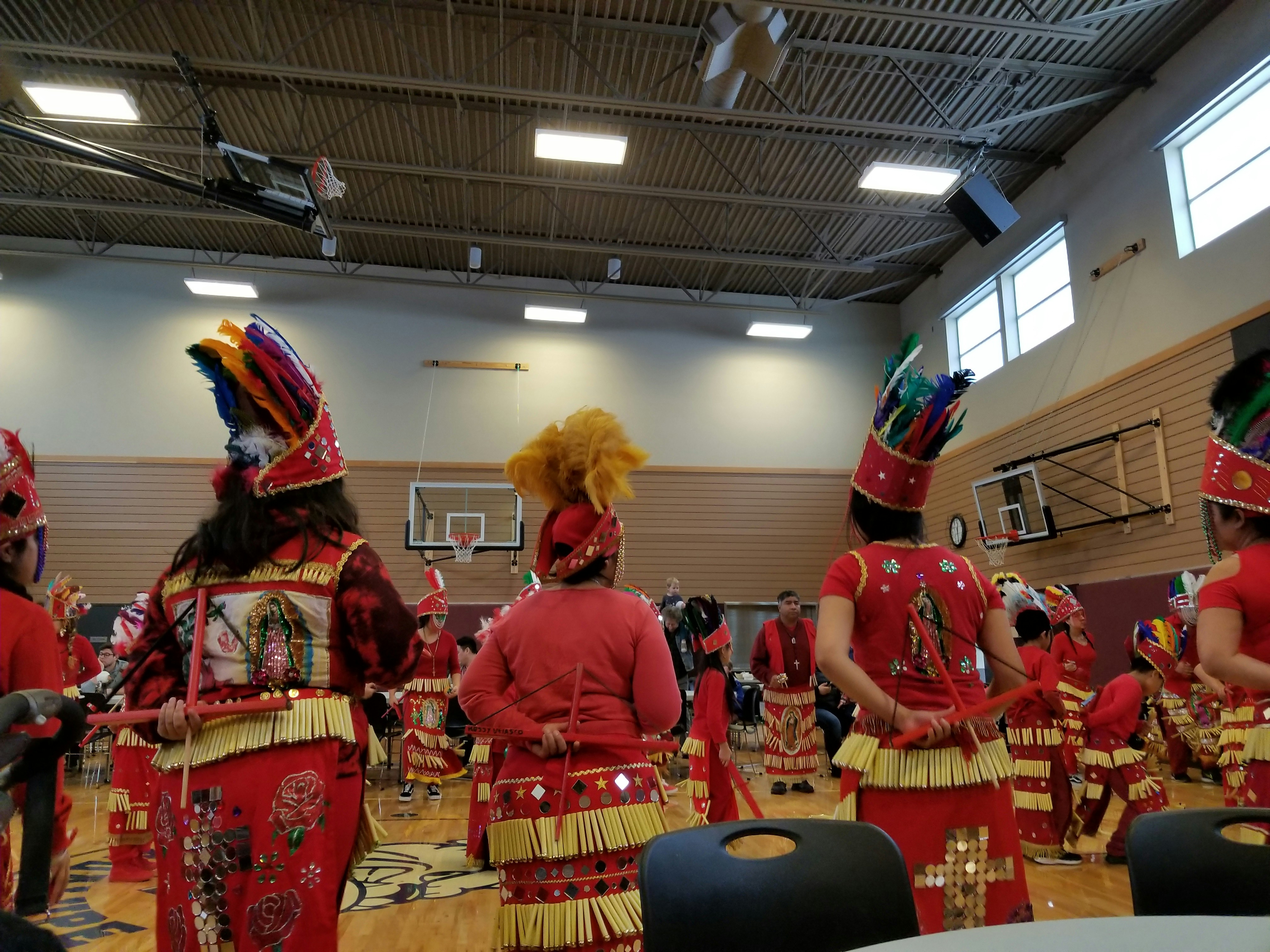 Traditional Caribbean cultural festival dancers performing in bright orange and gold costumes