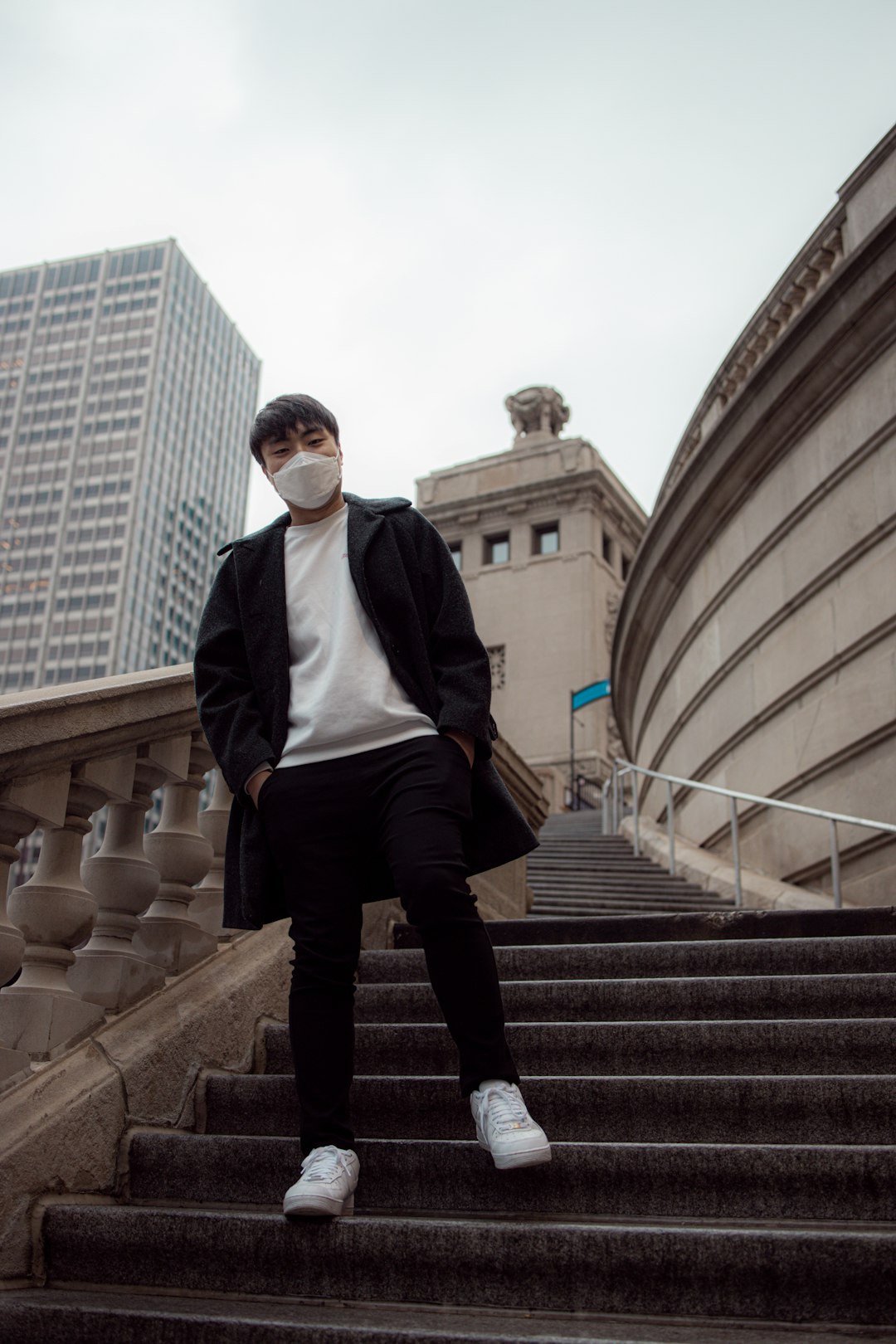 man in black vest and black pants standing on stairs