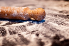 brown wooden smoking pipe on white and blue textile