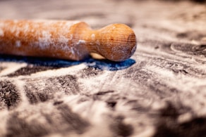 brown wooden smoking pipe on white and blue textile