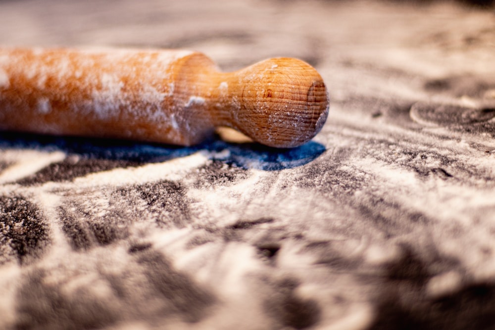 brown wooden smoking pipe on white and blue textile