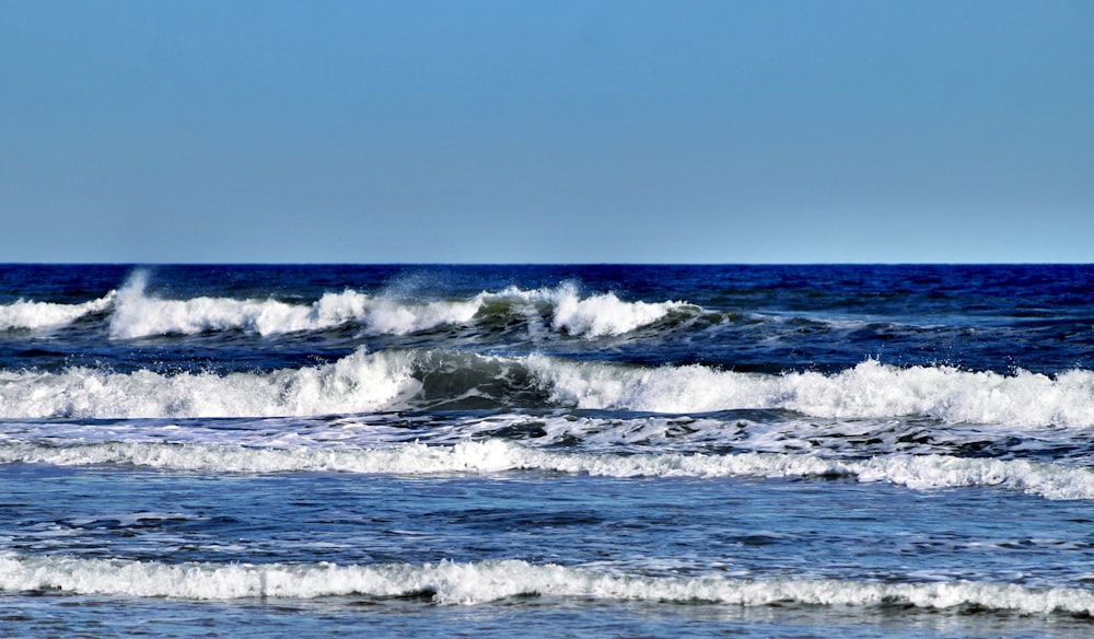 ocean waves crashing on shore during daytime