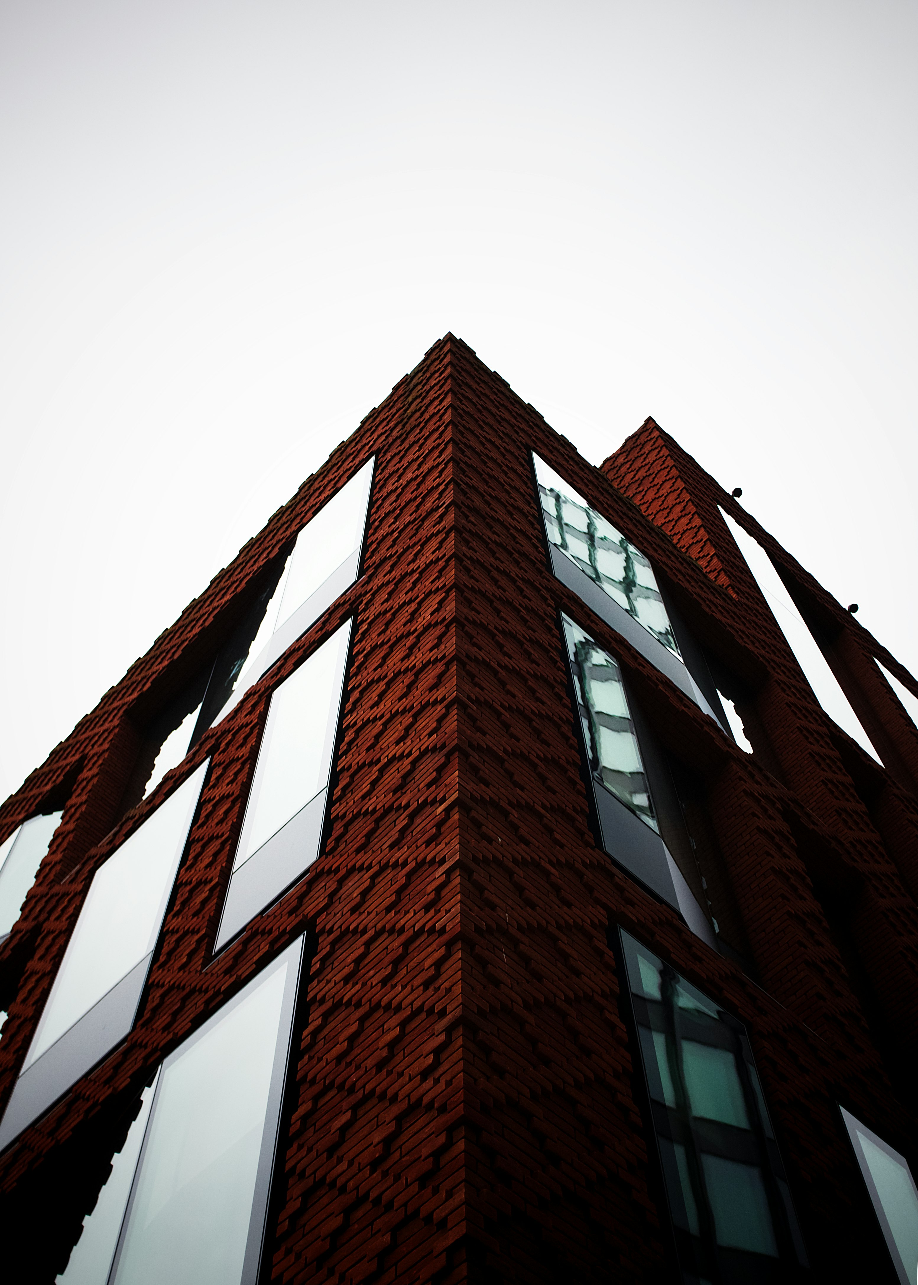 brown brick building with red metal frame