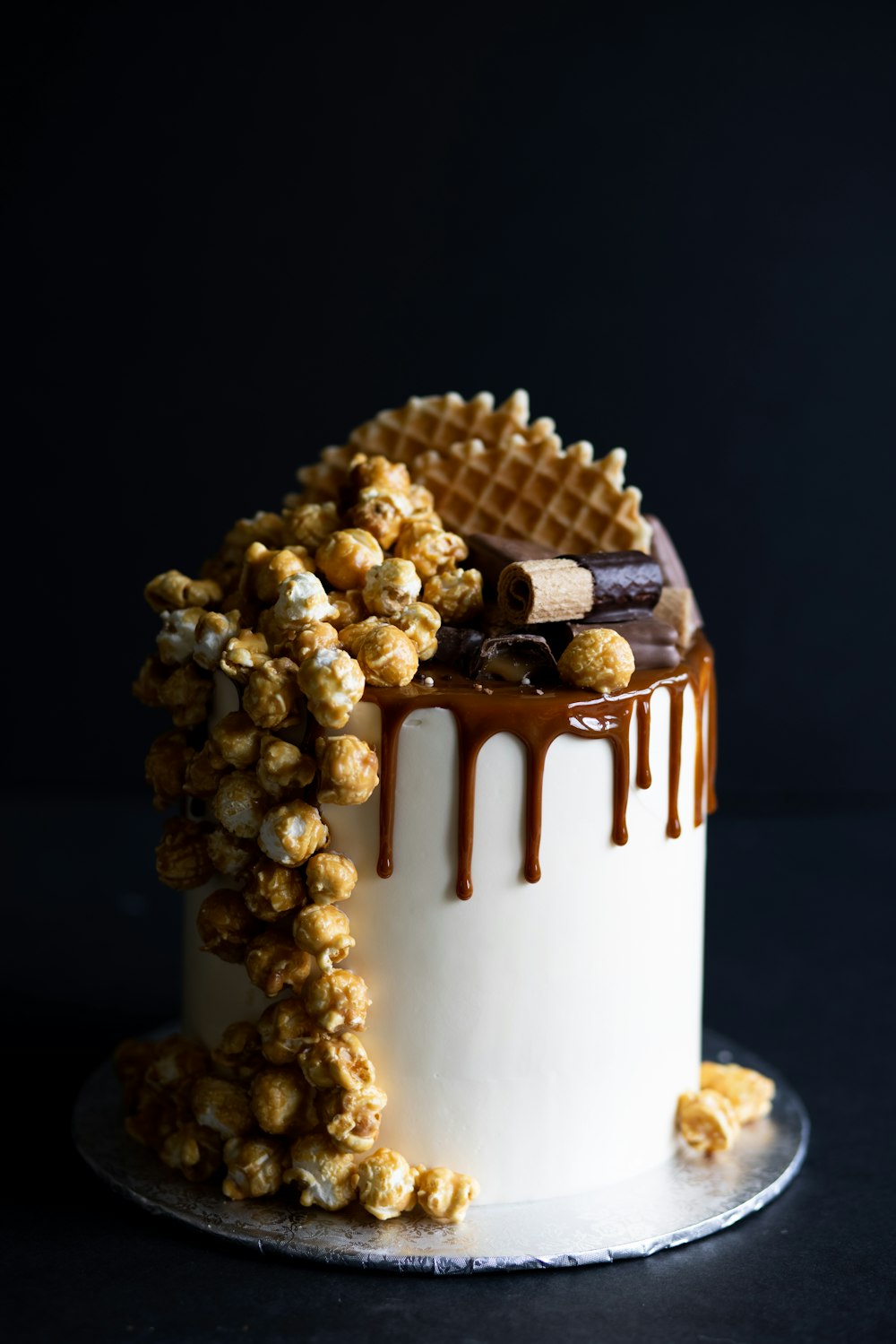 white and gold cake with white flowers