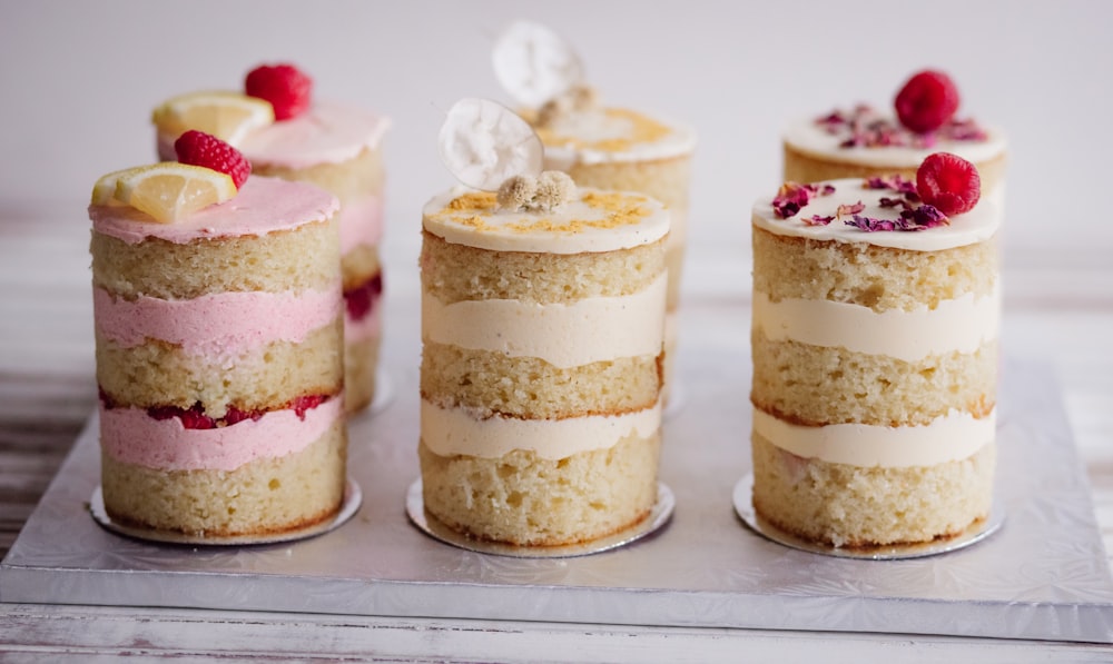 white and brown cupcakes with white icing and strawberry on top