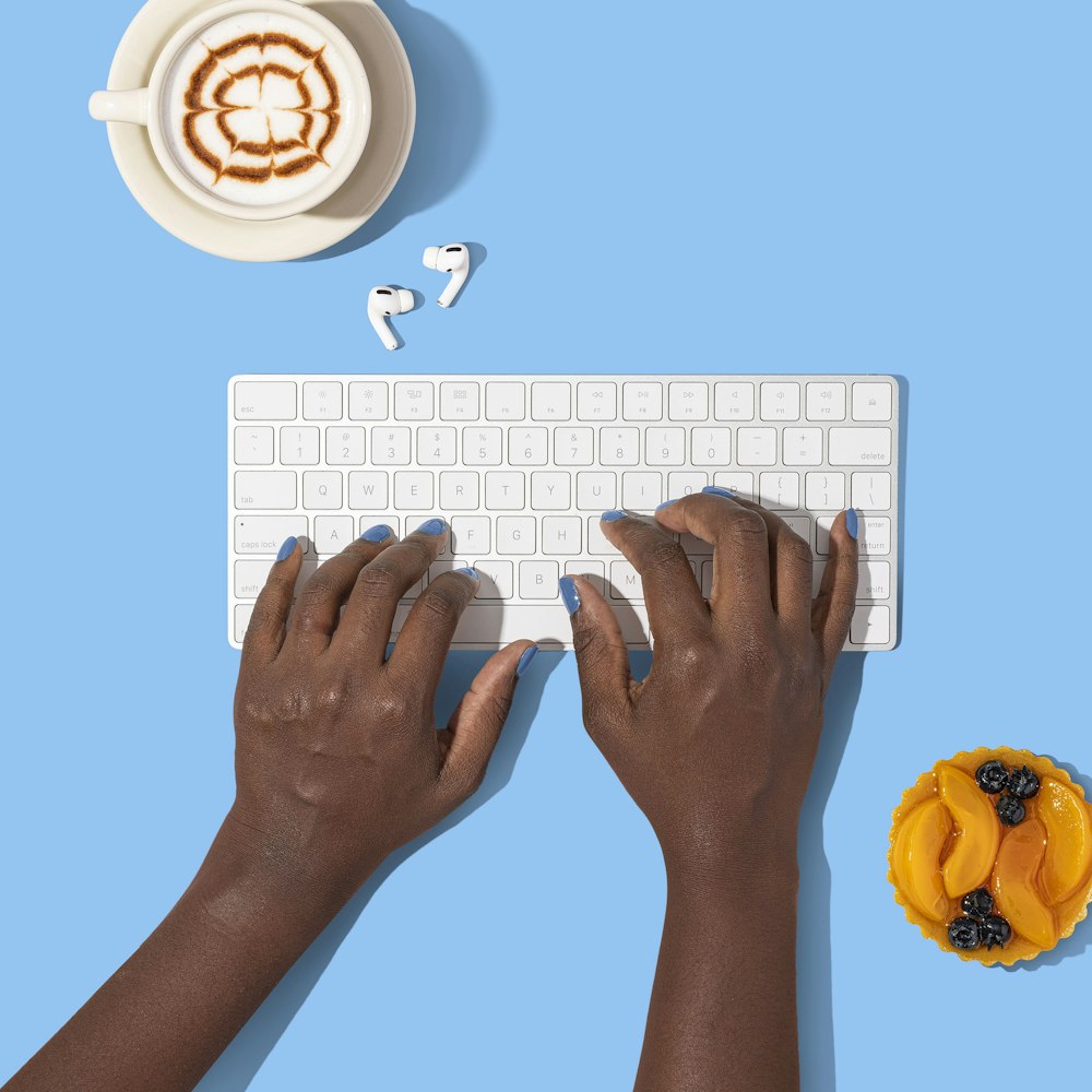 person holding white computer keyboard