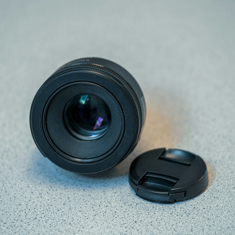 black camera lens on white surface