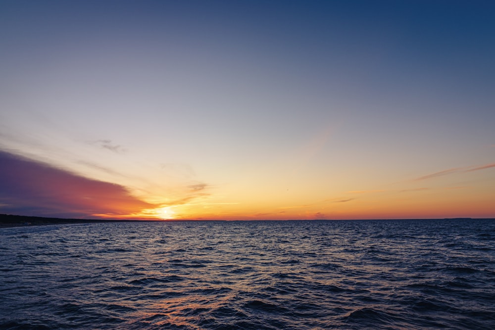 body of water during sunset