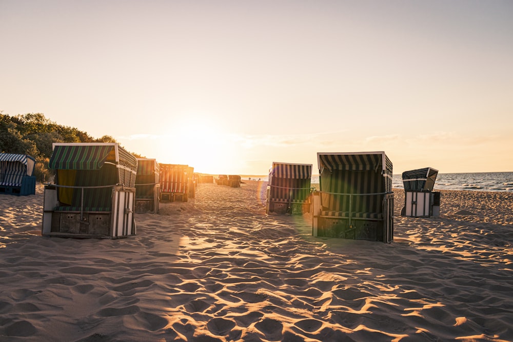 brown wooden houses on brown sand during daytime