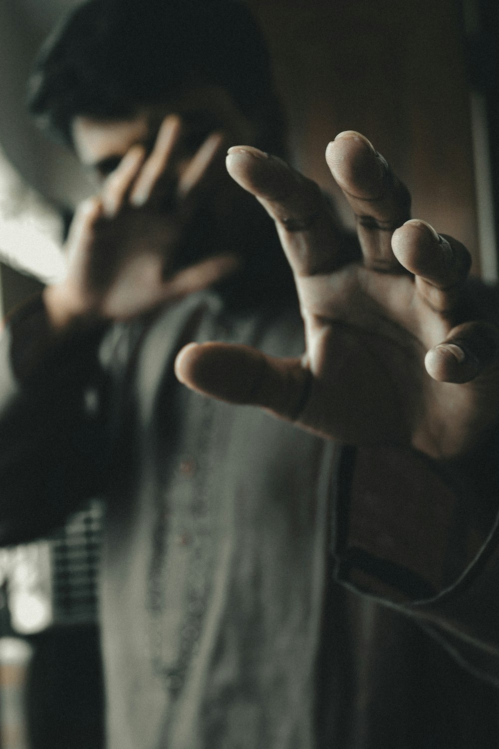 persons hand doing peace sign