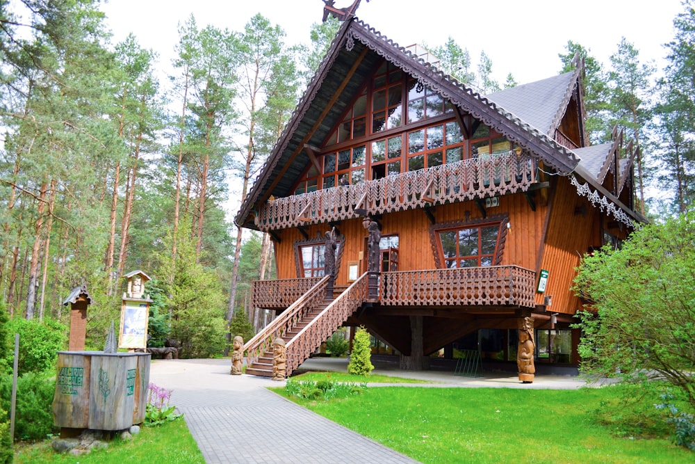 brown wooden house surrounded by green grass field