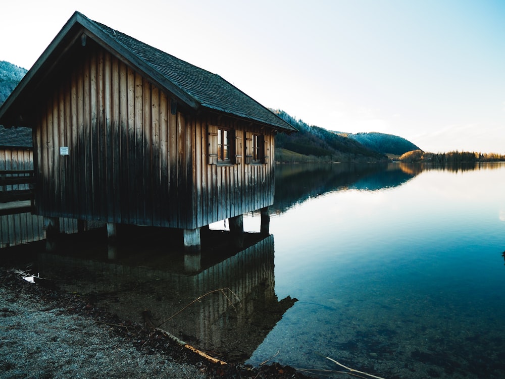 brown wooden house on water