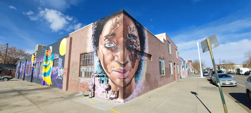 People gathered outside a brick storefront on a walkable street