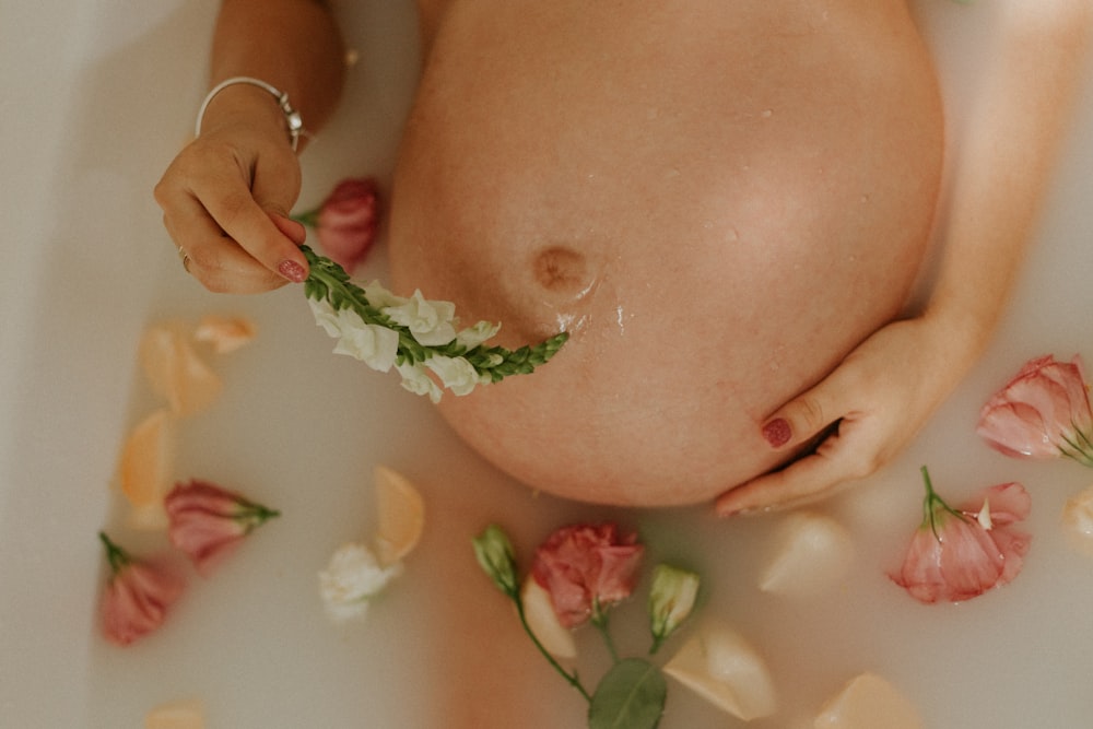 woman with pink and white flowers on her breast