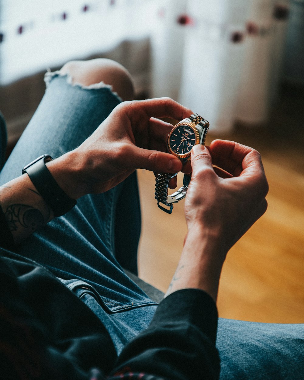 person wearing gold and black ring