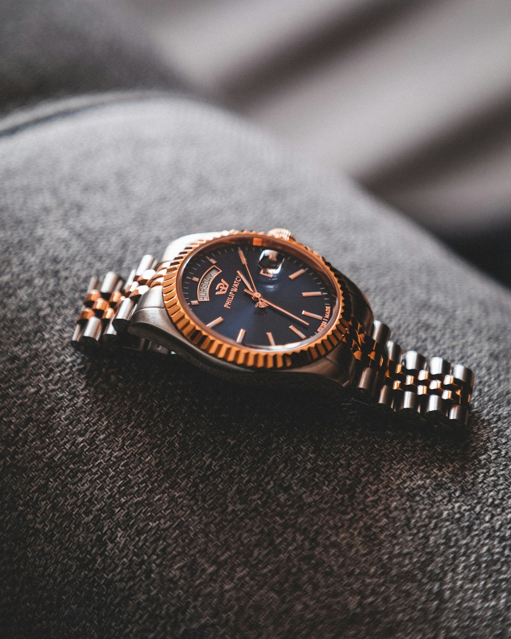 blue and gold round analog watch