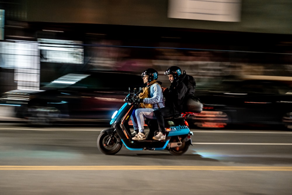 man in black helmet riding on blue and black motorcycle
