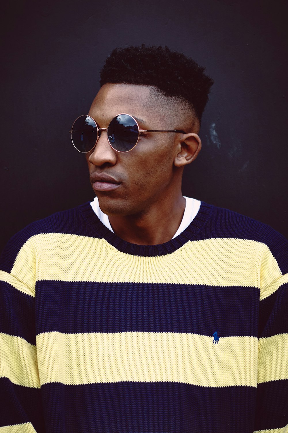 man in blue and white striped crew neck shirt wearing black sunglasses