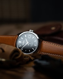 brown leather strap silver round analog watch