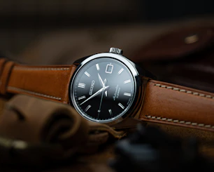 brown leather strap silver round analog watch