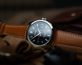 brown leather strap silver round analog watch