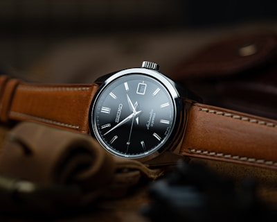 brown leather strap silver round analog watch