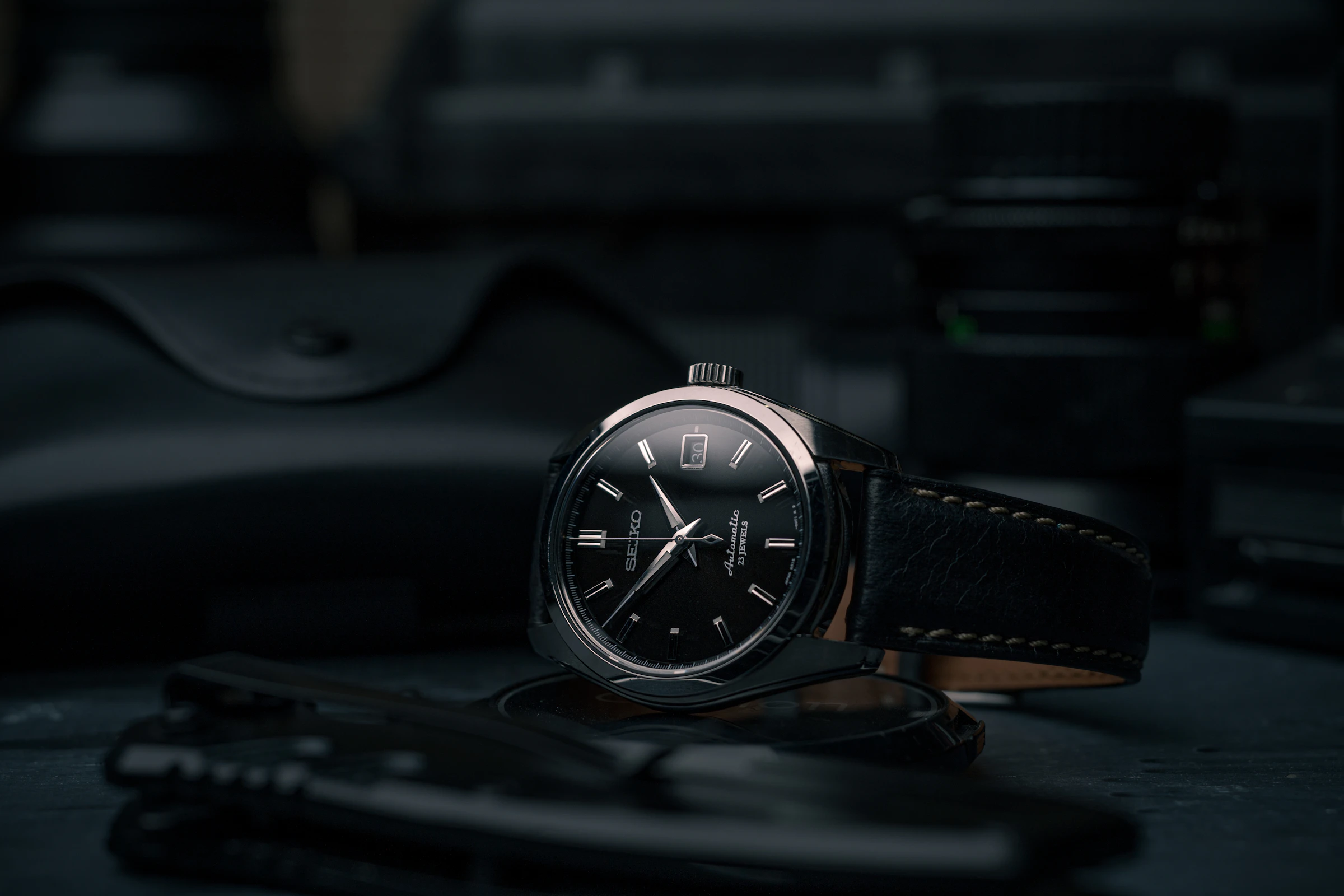 Black enamel dial in low studio light