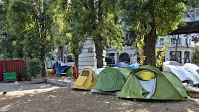 Volunteers setting up a free medical camp tent in a community park.