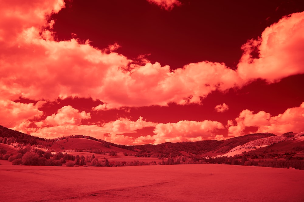 silhouette of mountains under cloudy sky during sunset