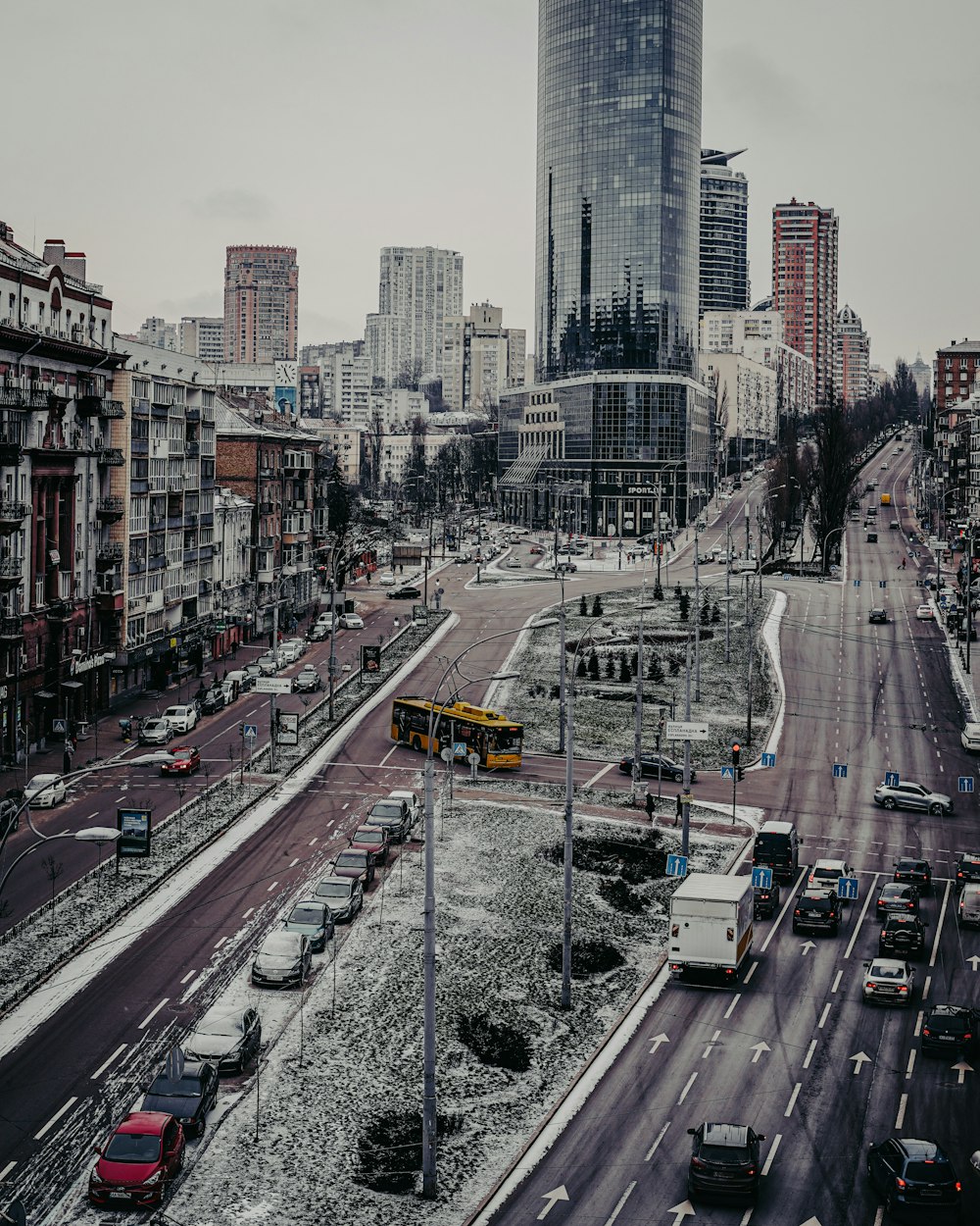 cars on road near city buildings during daytime