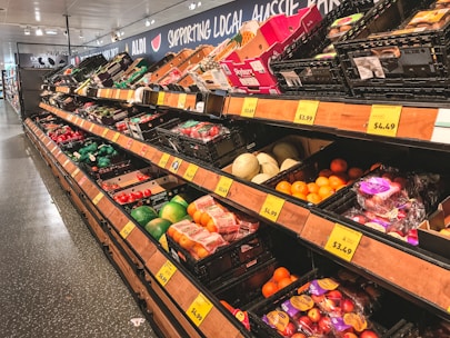 assorted fruits on brown wooden shelf