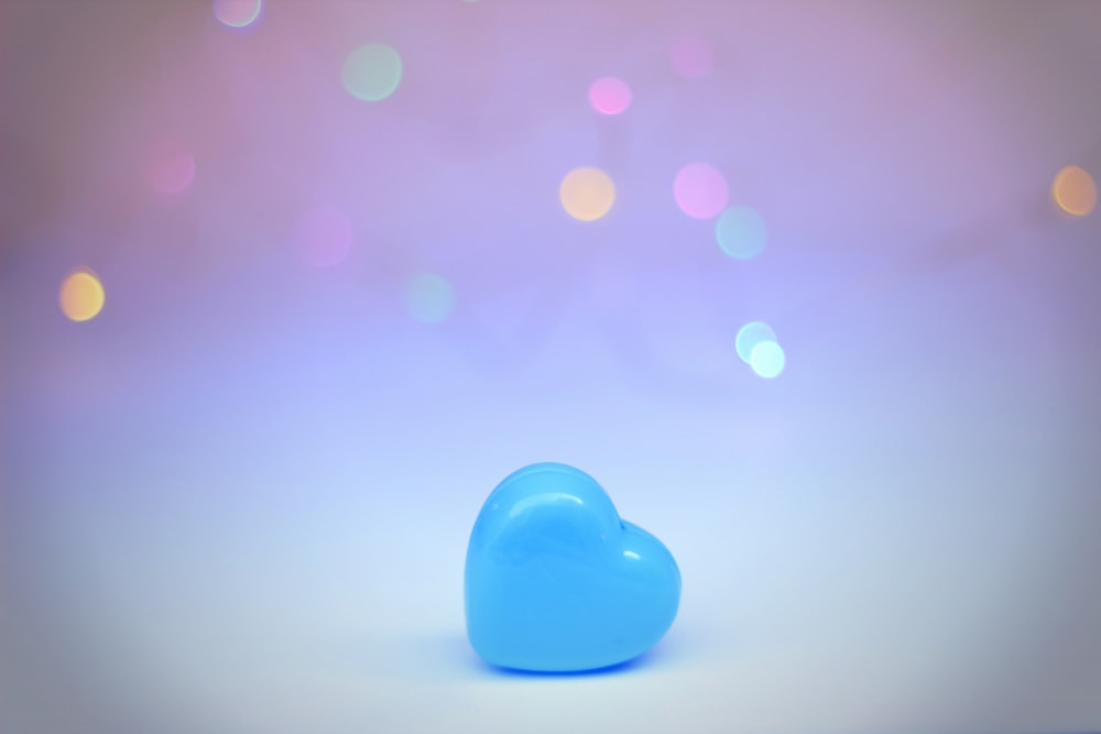 blue heart ornament on white surface