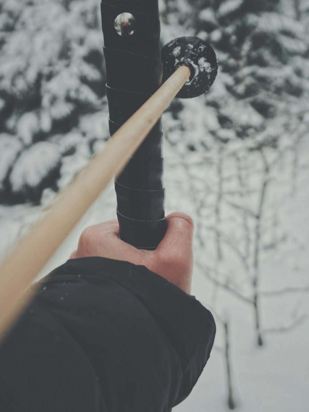 person holding yellow and black metal rod