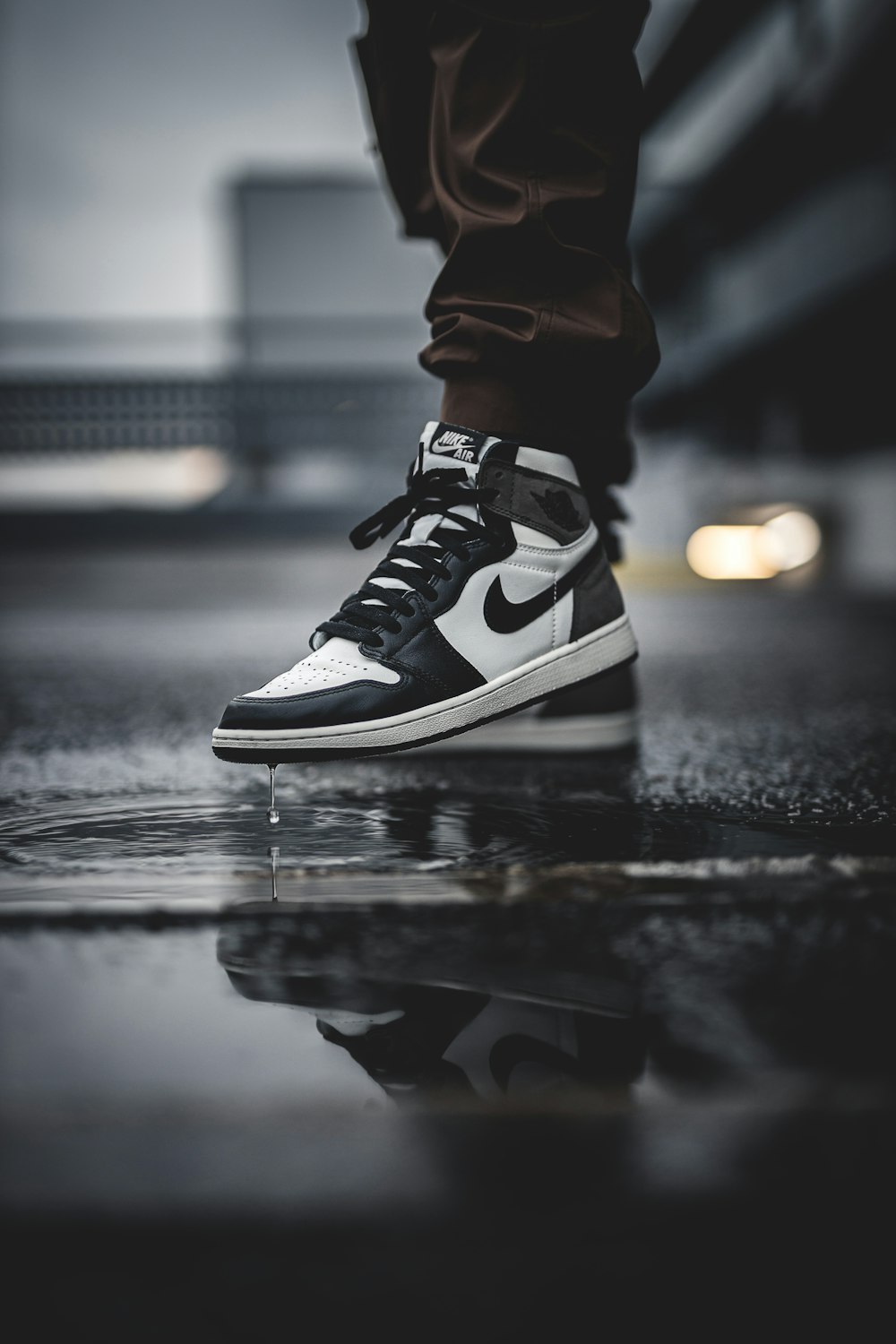 Person sitting and holding white, orange, and black Air Jordan 1 low-top  sneaker photo – Free London Image on Unsplash