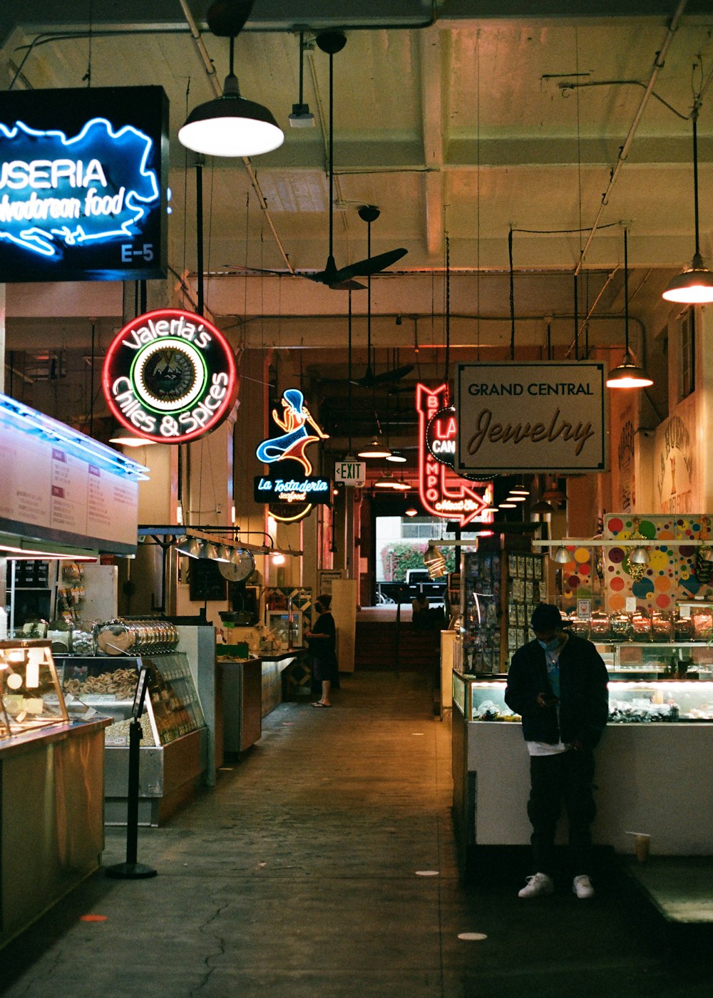 man in black jacket standing near counter