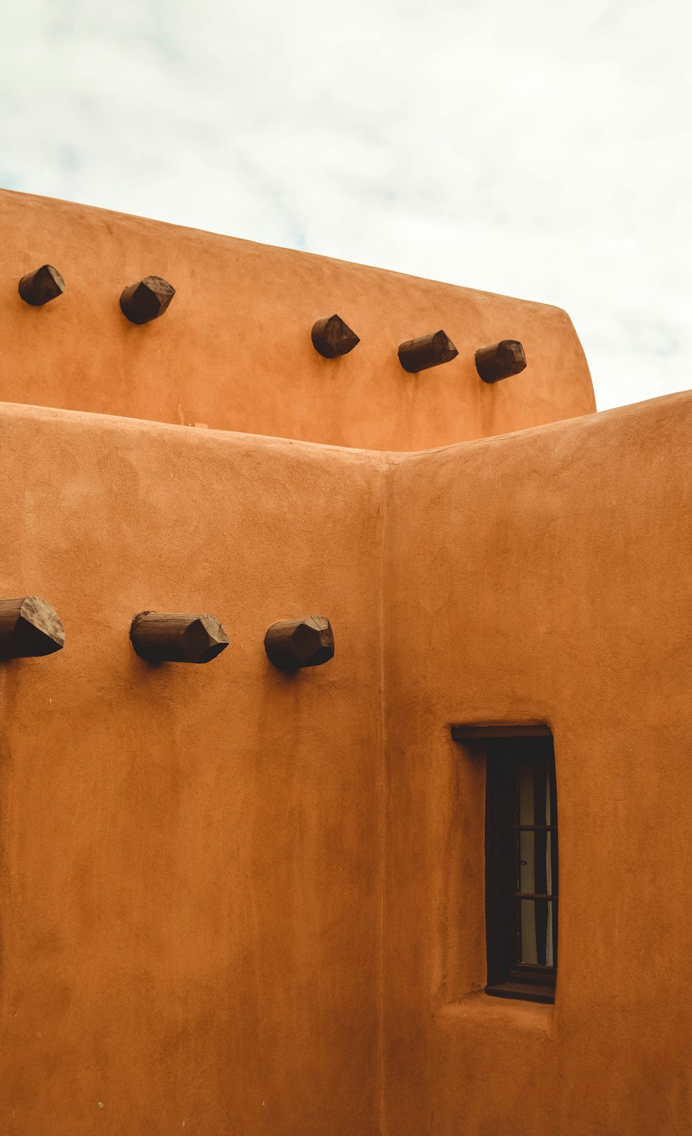 black sconce lamp on brown concrete wall