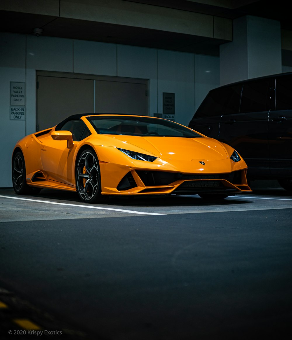 orange lamborghini aventador parked in garage