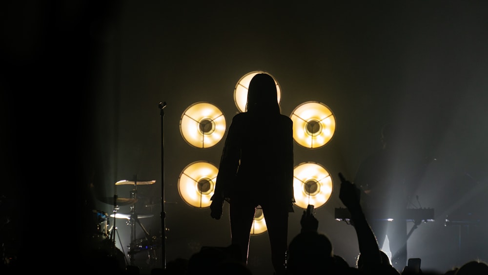 silhouette of man and woman standing on stage