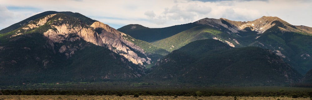 green and brown mountains under white sky during daytime